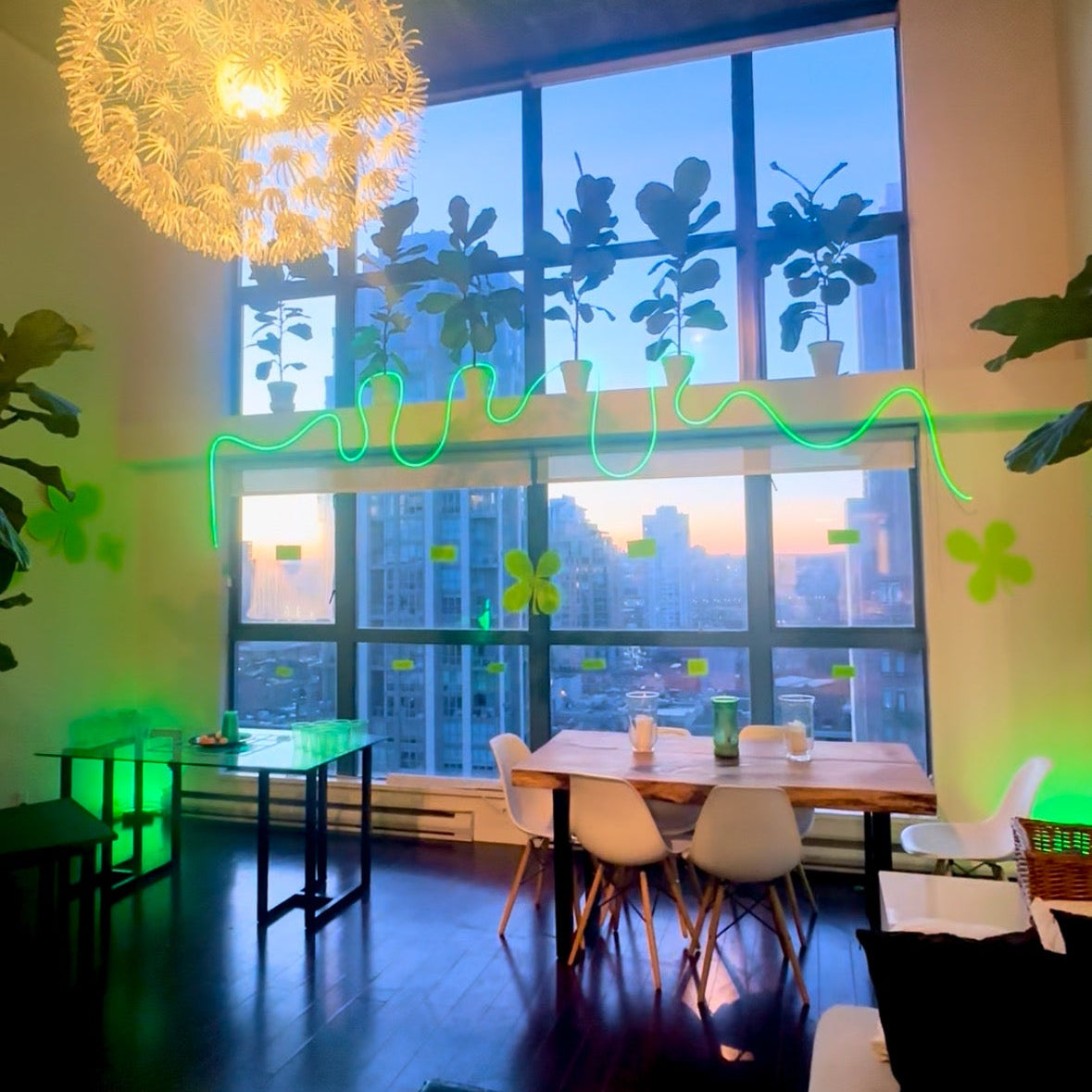 Modern interior with a large window, decorative lights, and furniture.