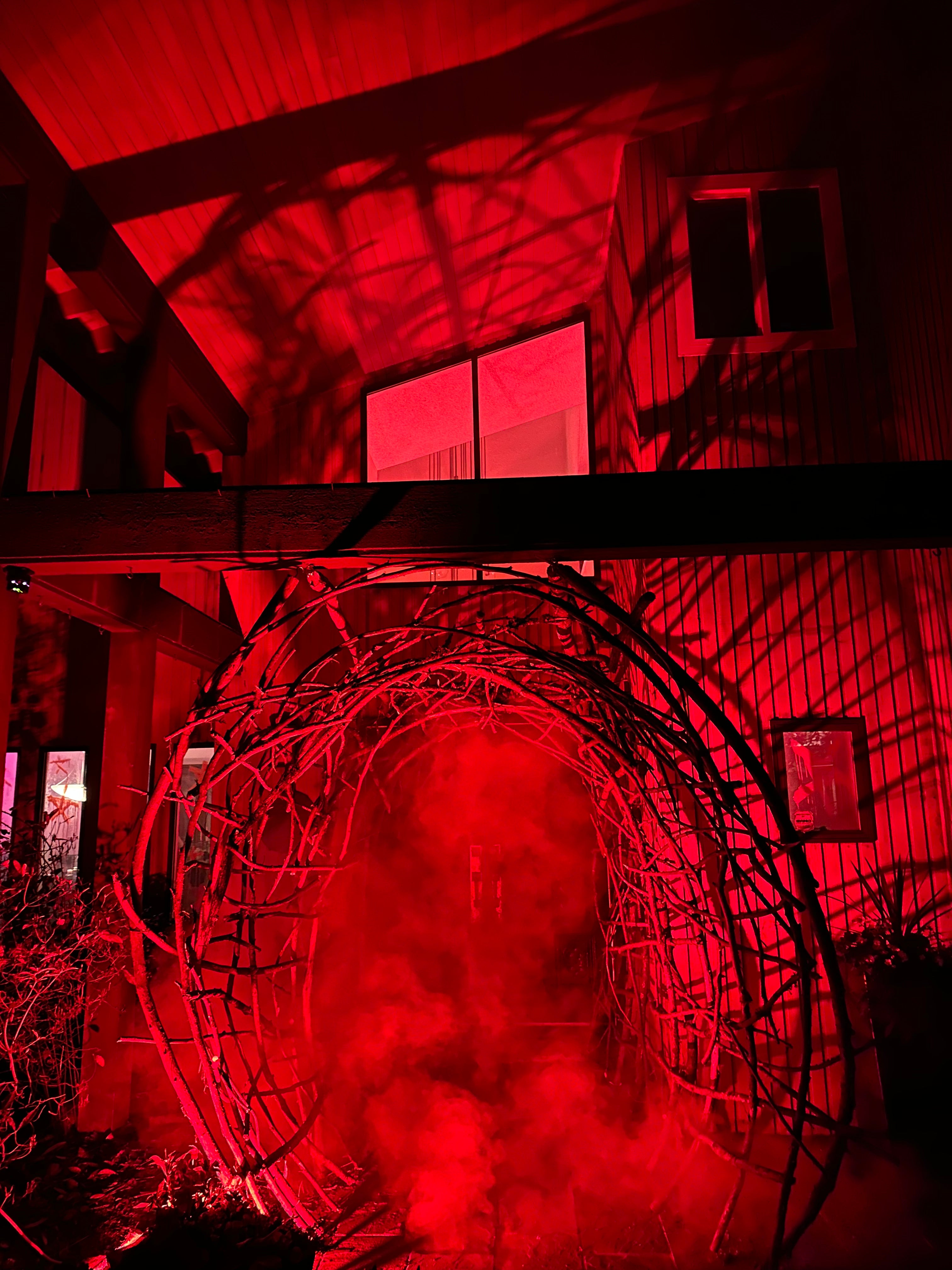 Red-lit interior of a building with a circular architectural feature.