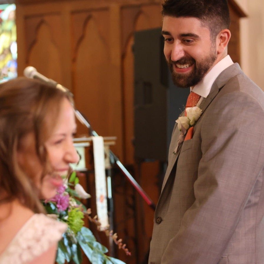 Man and woman in wedding attire in a church setting