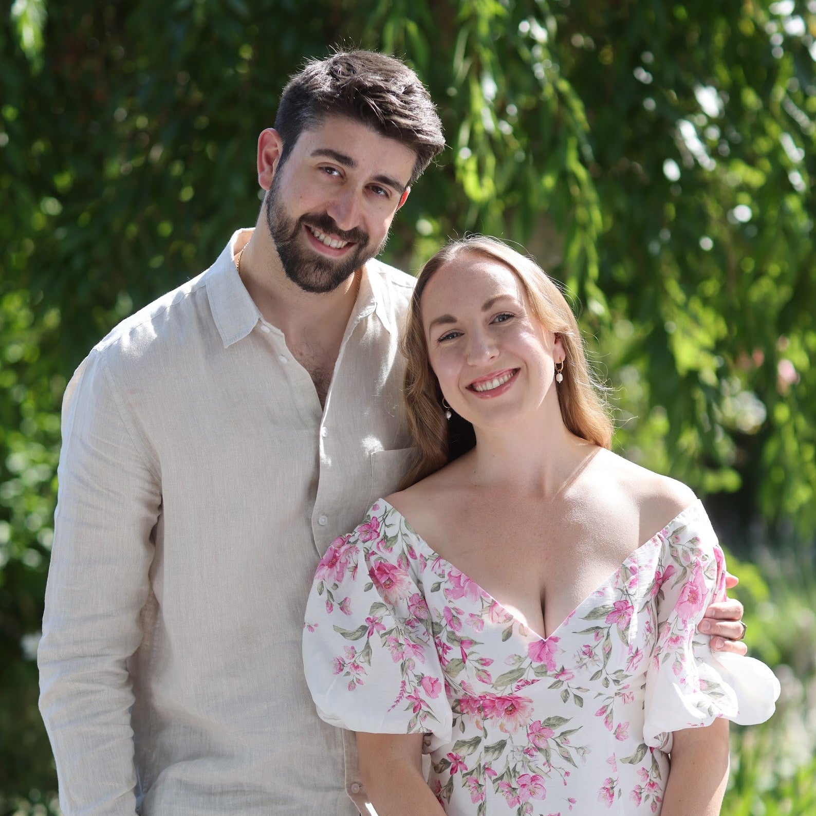 Man and woman standing together in a garden setting