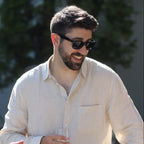 Three people engaged in a conversation outdoors with a blurred background