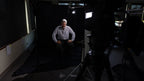 sitting in a dark room with camera equipment aroundavid 