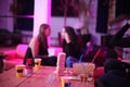 People sitting around a table with drinks in a social setting