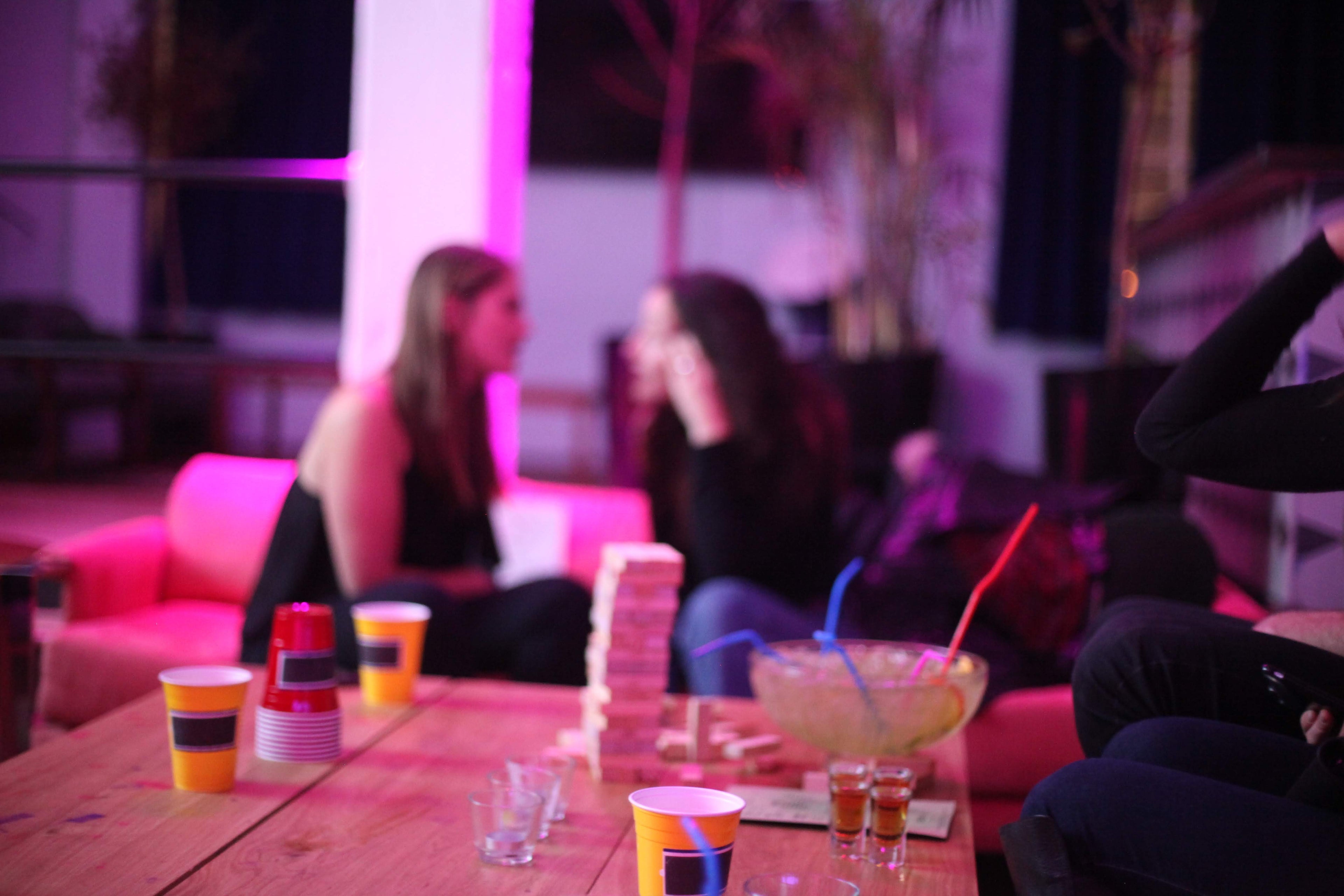 People sitting around a table with drinks in a social setting