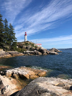 Your product, shot on a rocky cliff with a lighthouse by the water