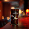 Dark glass with 'INEDIT' branding on a blurred street background
