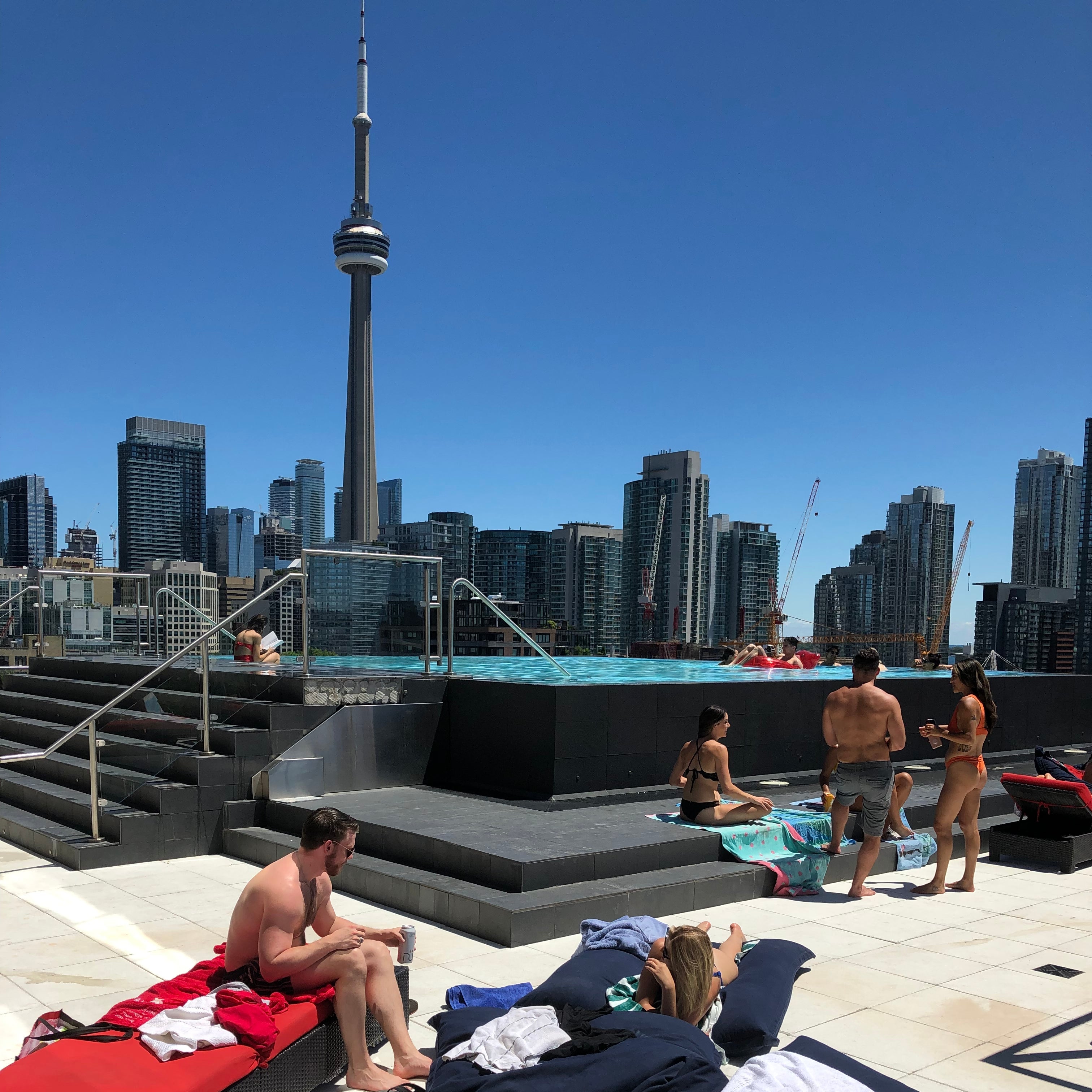People sitting on a bench with a city skyline in the background