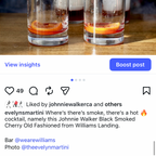 Two cocktails with orange slices in clear glasses on a wooden surface, with a blurred background.