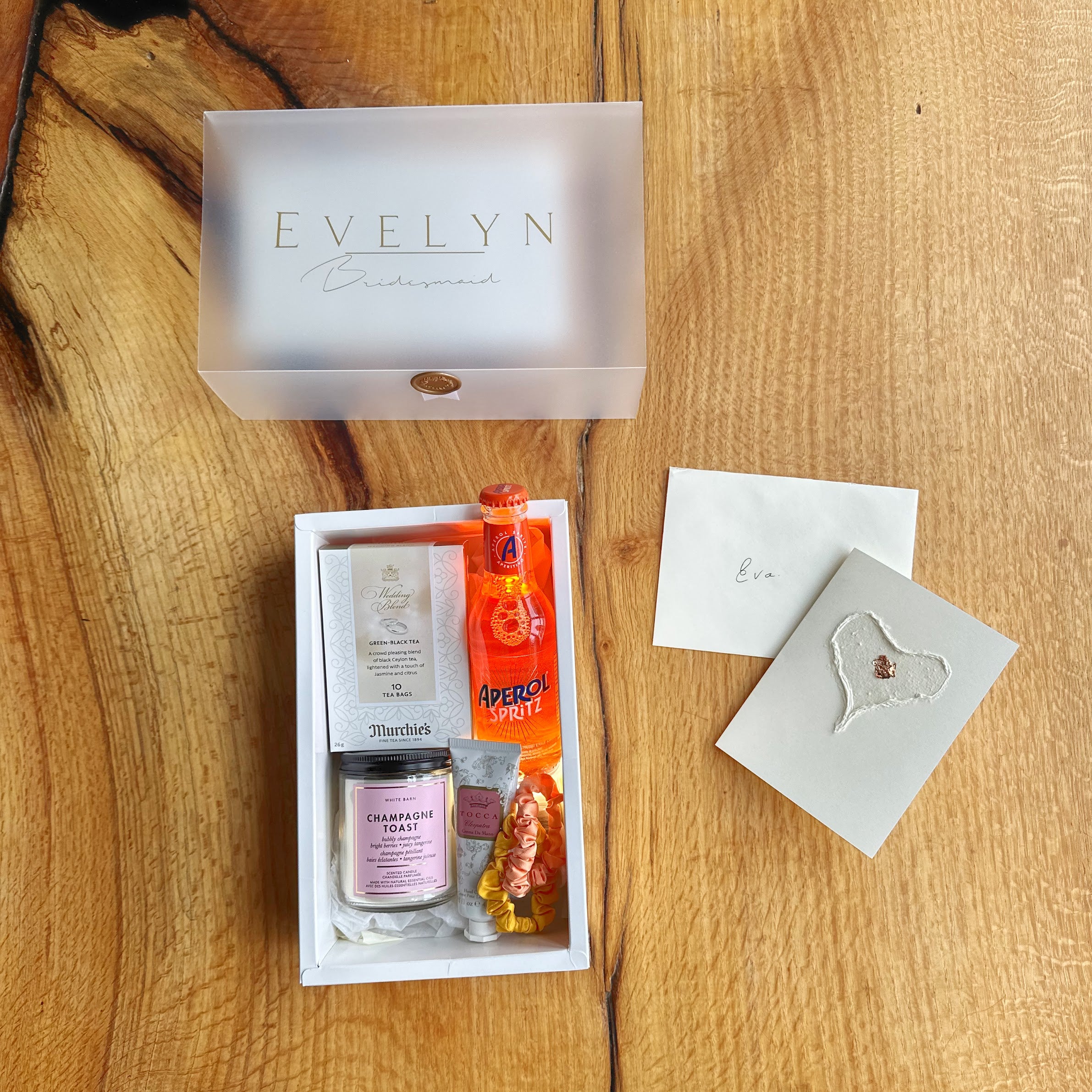 Gift set with 'Evelyn' branding on a wooden surface