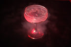 Red cocktail in a glass with a dark background