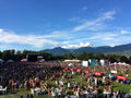 Squamish music festival with attendees, stages, and mountains in the background photographed from vip brand activation for Budweiser by Evelyn Martin. 