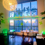 Modern interior with a large window, decorative lights, and furniture.
