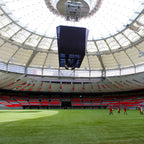 Stadium with a large screen and people on the field