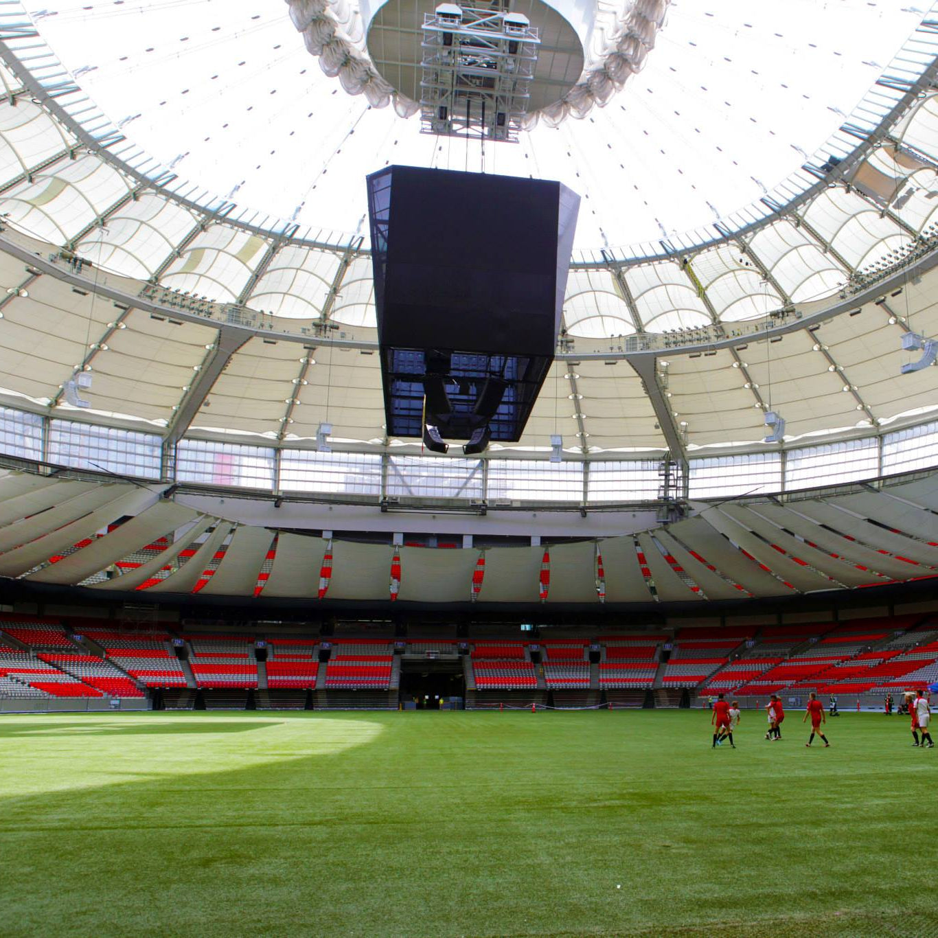 Stadium with a large screen and people on the field