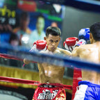 Two boxers in a boxing ring with a blurred background