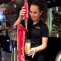 Evelyn Martin pouring a drink from a Budweiser tap at the Labatt office bar