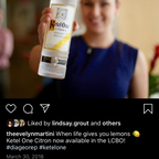 Person holding a bottle of Kahláu with a blurred background