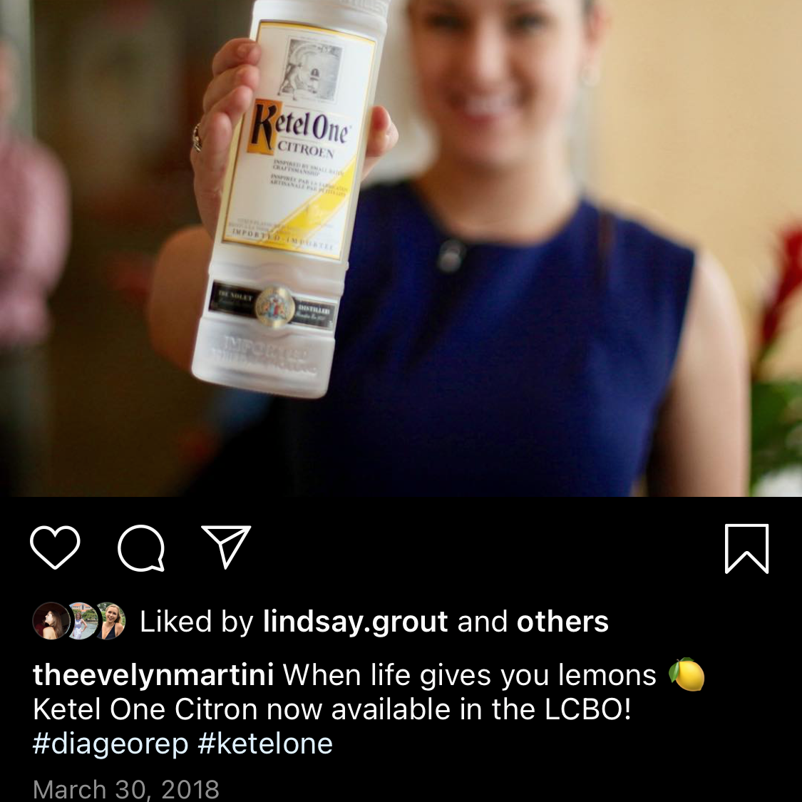 Person holding a bottle of Kahláu with a blurred background